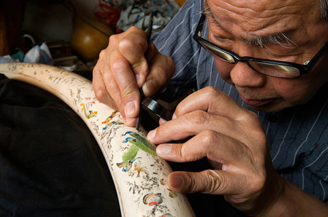 Mark_Leong_7 BEIJING, CHINA. Chen Jipin, 82, has been carving ivory since he was 13 years old. Here he adorns a tusk with the classic Chinese story, A Hundred Birds Facing the Phoenix. With the dwindling supply of legal, old ivory, the membership of his carving association is also decreasing - the youngest member is now 45 years old.