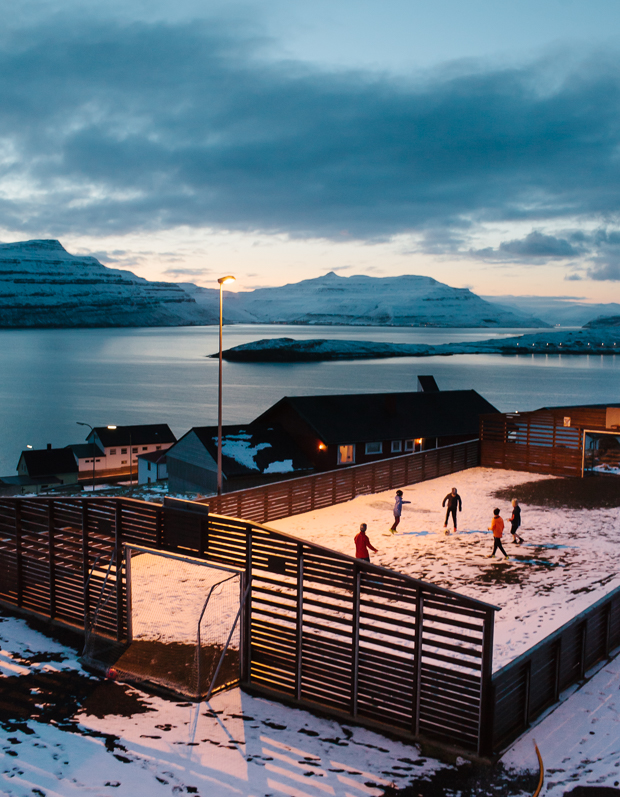 Children playing football in the village of Nes, Faroe Islands. March 2016.