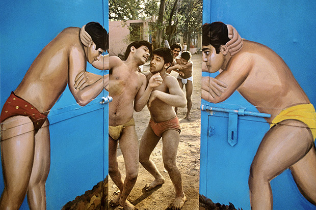 INDIA. Delhi. Wrestlers through the painted gate, Paharganj. (year unknown)
