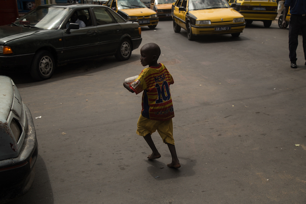 Talibe asking for money in the steets of Dakar city center.