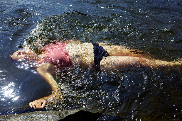 A women cools down in a river.