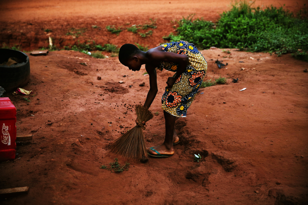 Every morning before school, Patience sweeps the yard around her family's home.